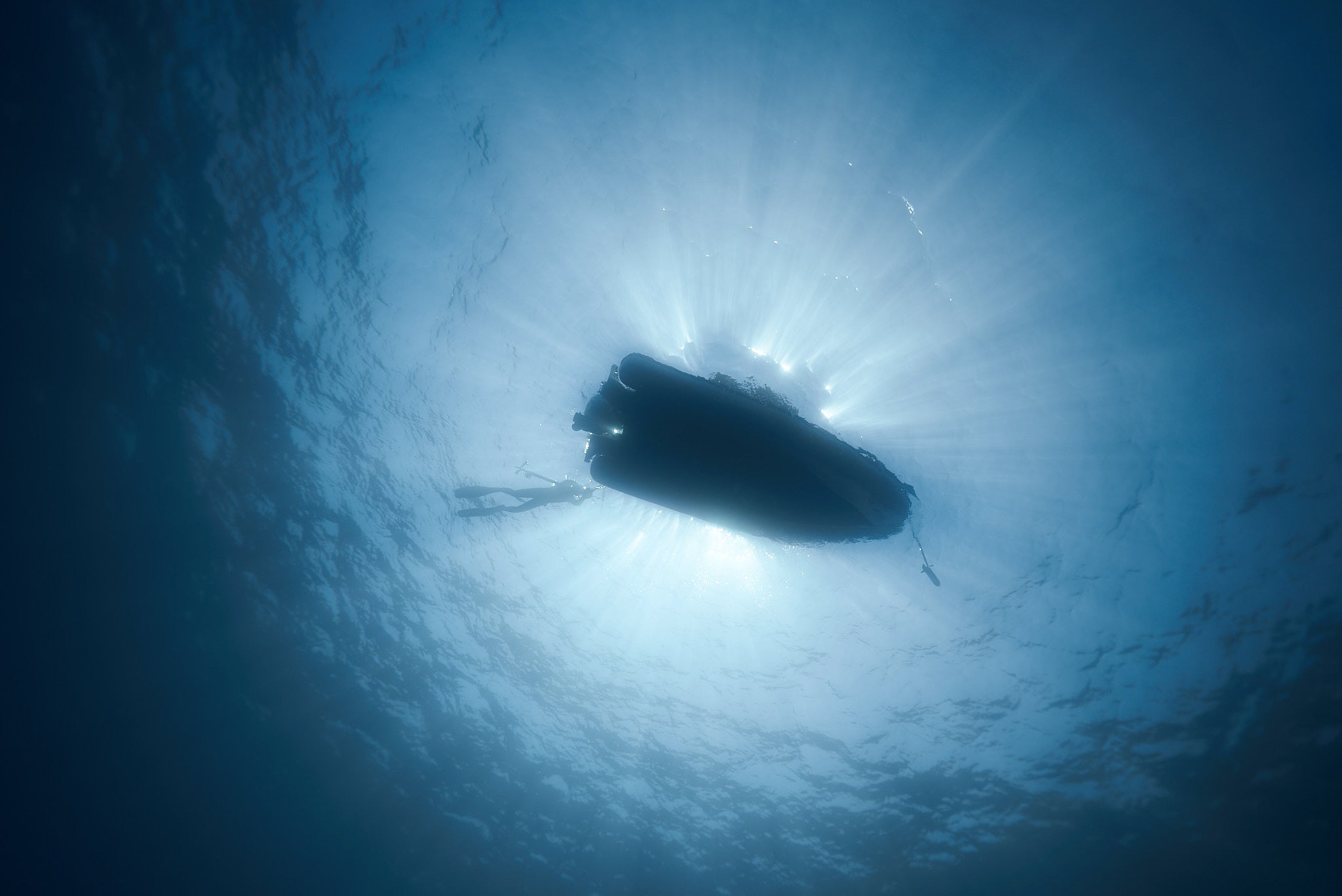 An ocean view with a boat, symbolizing adventure and exploration in freediving and spearfishing with Giovanni Bianco