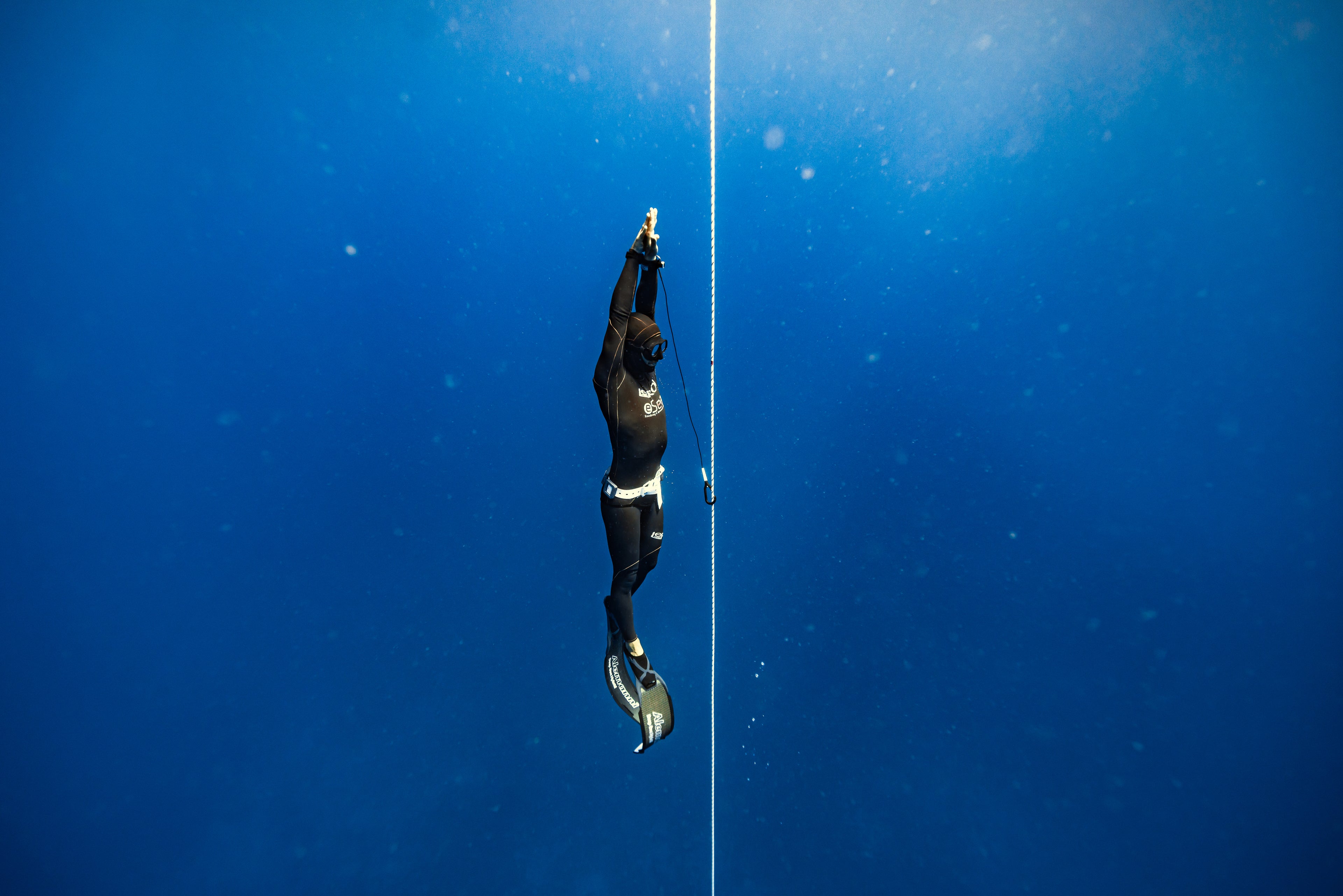 Giovanni Bianco practicing freediving in the clear blue sea, showcasing expert technique and safety